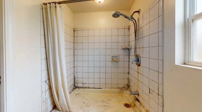 stained tile shower before liner installation